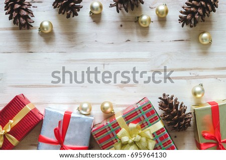 Christmas background with decorations and gift boxes on wooden table. Top view with copy space.