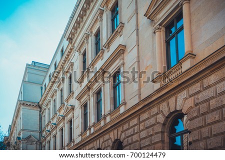 Detail view on faux column windows and corbelled arches on neoclassical design building
