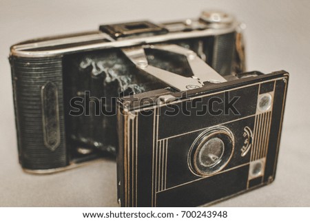 Old vintage retro camera still life on fabric background close up