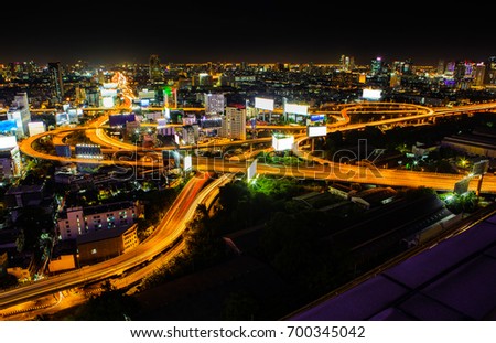 Bangkok modern office buildings with Highway intersection,city scape at night