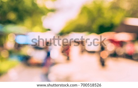 Abstract Blurred image of day market on street  with bokeh for background usage . (vintage tone)