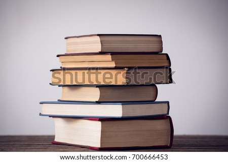 Stack of books on table against wall