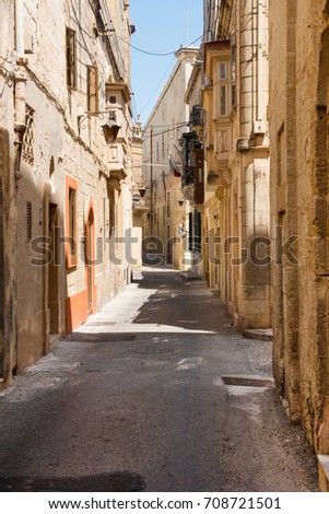 Narrow medieval street with stone houses in Mdina citadel (Silent city), Malta. Mdina is one of Game of Thrones movie filming locations in Malta