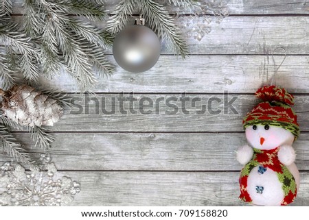 Snowman and Christmas decorations on wooden background. Space for text.