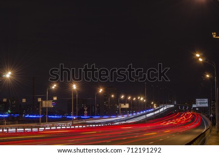The headlights of passing cars on the overpass bunk