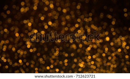 Golden lights bokeh defocus abstract background. Gold Festive Christmas. Glitter twinkled bright background.