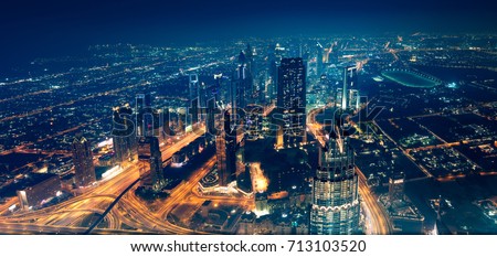 Panoramic view of Dubai city, beautiful modern new town at night with many bright glowing lights from the towers, magical place for traveling