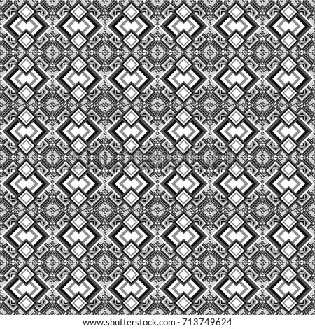 Gray, white and black ethnic geometric motif seamless pattern in gray, white and black on abstract background.