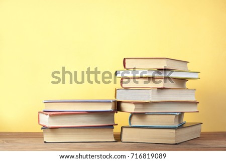 Stack of colorful books on wooden table. Back to school. Copy space for text. Education concept.