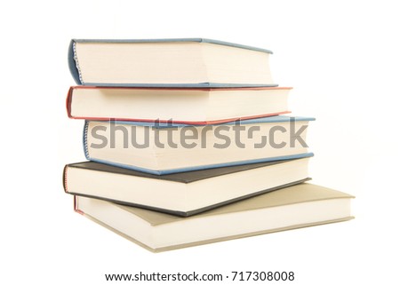 Staple of five books seen from the front isolated on a white background