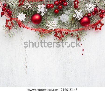 Fir branch with Christmas decorations on old wooden shabby background with copy space for text.