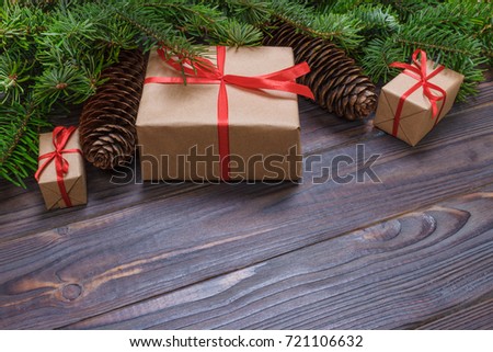 Christmas gift box. Christmas presents in red boxes at black wooden table. Flat lay with copy space.