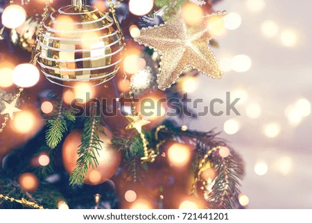 Gold Christmas background of de-focused lights with decorated tree
