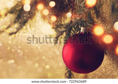 Red Christmas ball hanging on Christmas tree.