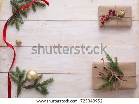 Christmas gift boxes and fir tree branch on wooden table, flat lay. ?hristmas background