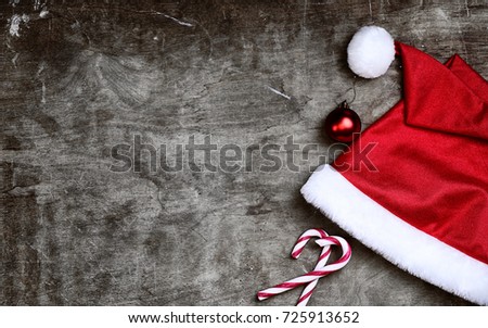 red santa hat on a textured wooden background