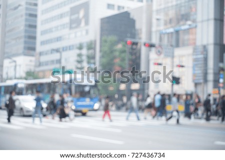Blurred background of busy city street people on zebra crossing