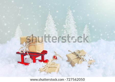 Christmas card, red wooden sled wrapped gift box, on snow, new year composition