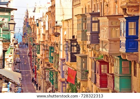 Famous landmark of hilly road with colourful balconies in the ancient city of Valletta, Malta