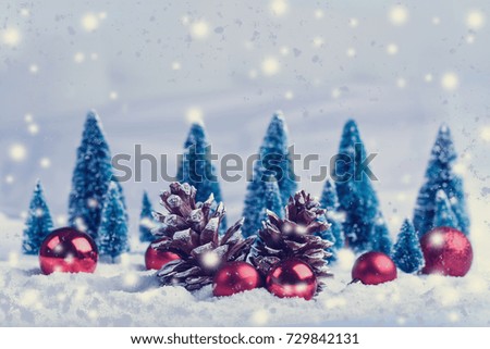 red christmas balls in the snow on nature background.