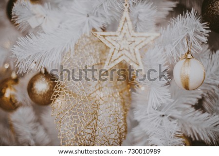 decorating christmas tree at home. Ornament close up on background of christmas tree with colorful lights and toys, copy space for text