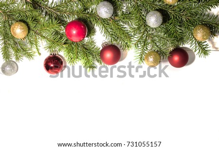 spruce branches with Christmas toys on a white background
