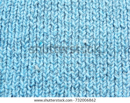Multicolored knitted pattern. Light blue, gray