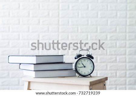 clock and book on the wooden table copyspace. 3