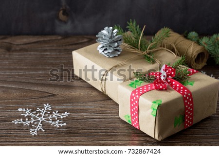 Christmas background with gift box. Christmas gifts in handmade boxes on a wooden table. Copy space.