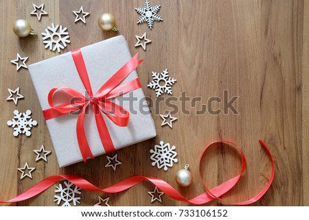 Christmas holidays and Happy New Year background. Gift boxes with red ribbon and Christmas decoration on wooden table. Top view with copy space.