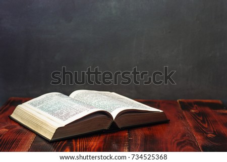 Bible on a wooden brown table. Beautiful blue background.Religion concept.