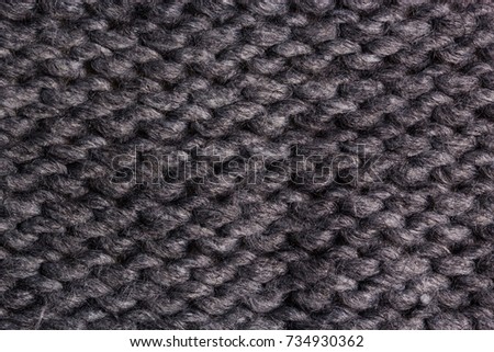 Winter Sweater Design. Grey knitting wool texture background. knitted fabric texture. Knitted jersey background with a relief pattern. Braids in knitting