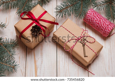 Christmas decorative fir background with craft gifts key red balls on wooden board holiday concept