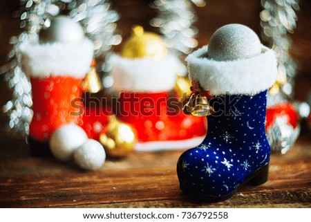 background, texture, on the theme of New year and Christmas: boots Santa with toys and gifts