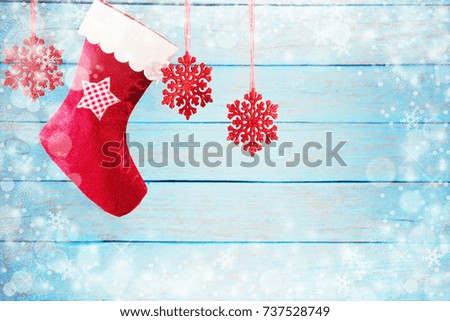 Christmas stocking hanging against wooden background