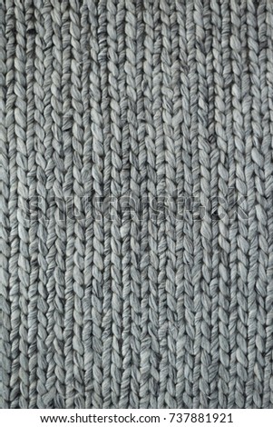 Real gray knitted fabric or wool background texture