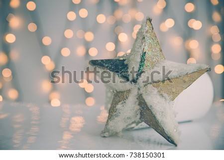 Shiny christmas ornament on white background with christmas lights.