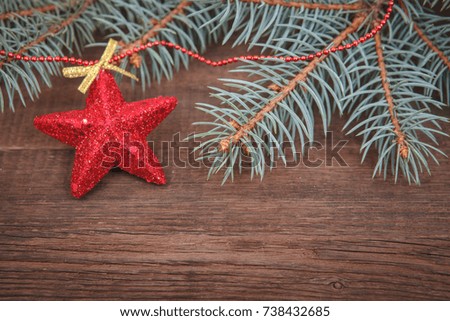 Christmas composition. Fir branches, red Christmas ornaments on a wooden brown background. Space for text, top view. Background