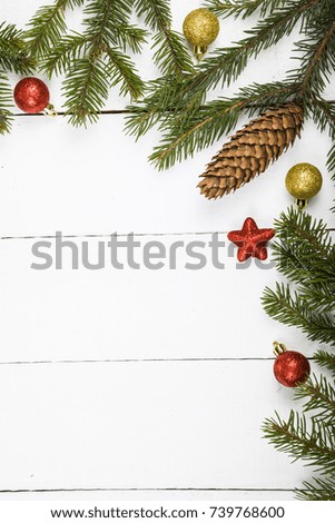 Spruce branch and balls. Christmas still life on a wooden table.Border.