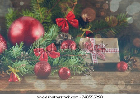 Happy New Year - a holiday background with fir, balls, cones on the wooden background, effect of bokeh. 
