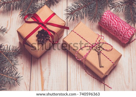 Christmas decorative fir background with craft gifts key red balls on wooden board holiday concept toned 