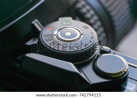 Close-up of mode and shutter speed dial of a vintage retro photo film camera     