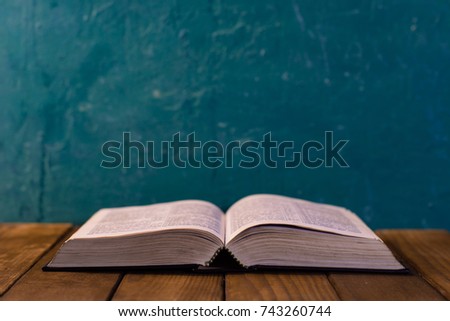 Bible on a brown wooden table. Beautiful background.Religion concept.