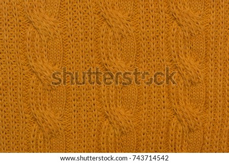 Knitted background. Knitted yellow texture. A knitting pattern of wool. Knitting. Background.