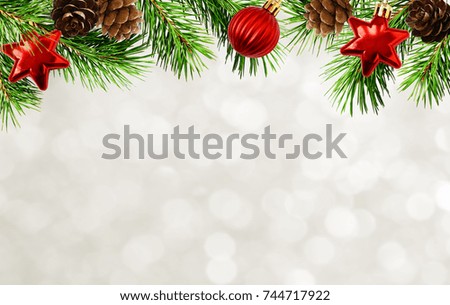 Holiday background with Christmas tree twigs, cones, balls and bokeh