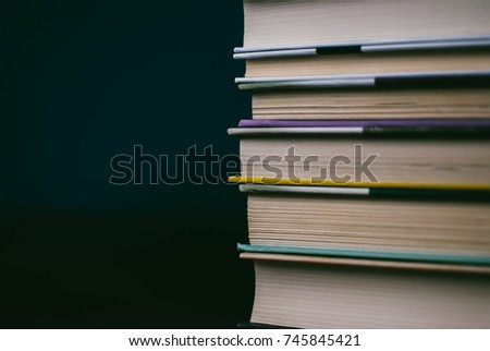 Heap of books on the cork board. Closeup of pages. Abstract concept of knowledge, education, learning, and literature. Black and white