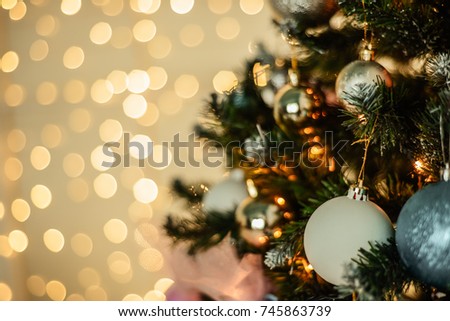 New Year background. New Year's garland and fir tree background.The fir tree is decorated with toys and lights