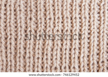 texture of knitted brown beige sweater close-up 