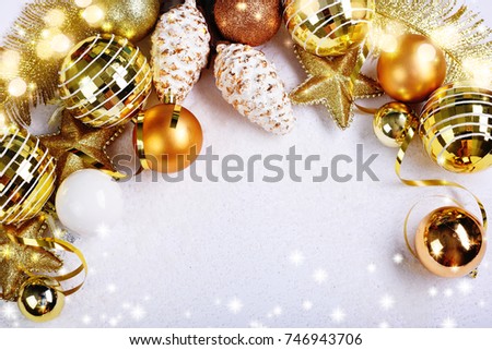 Golden Christmas border of baubles and shiny branches

