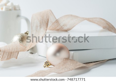 rose gold Christmas decorations and ribbon on a white background
